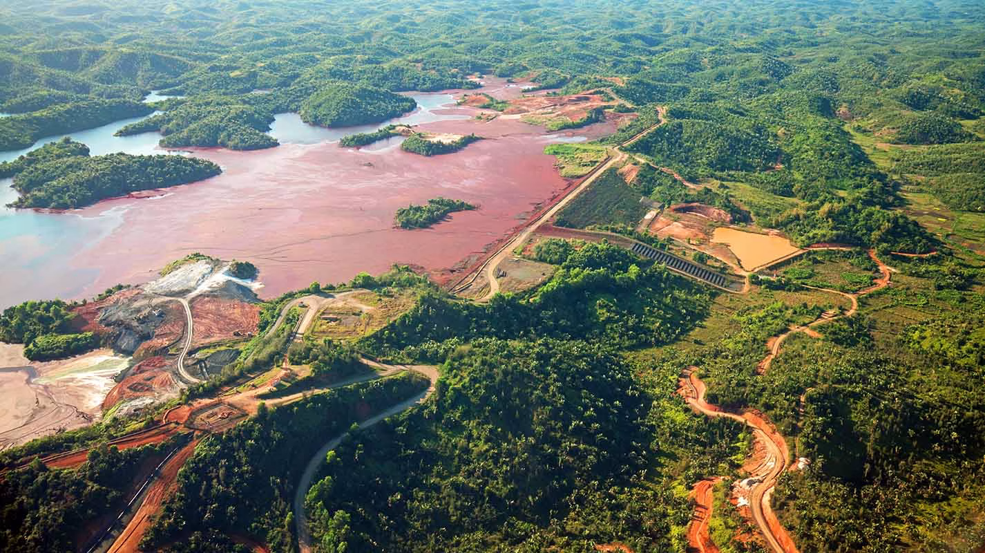 Imagem ilustrando o processo de modelagem tridimensional para a segurança de barragens de mineração, destacando a análise de fluxos subterrâneos e estabilidade estrutural.